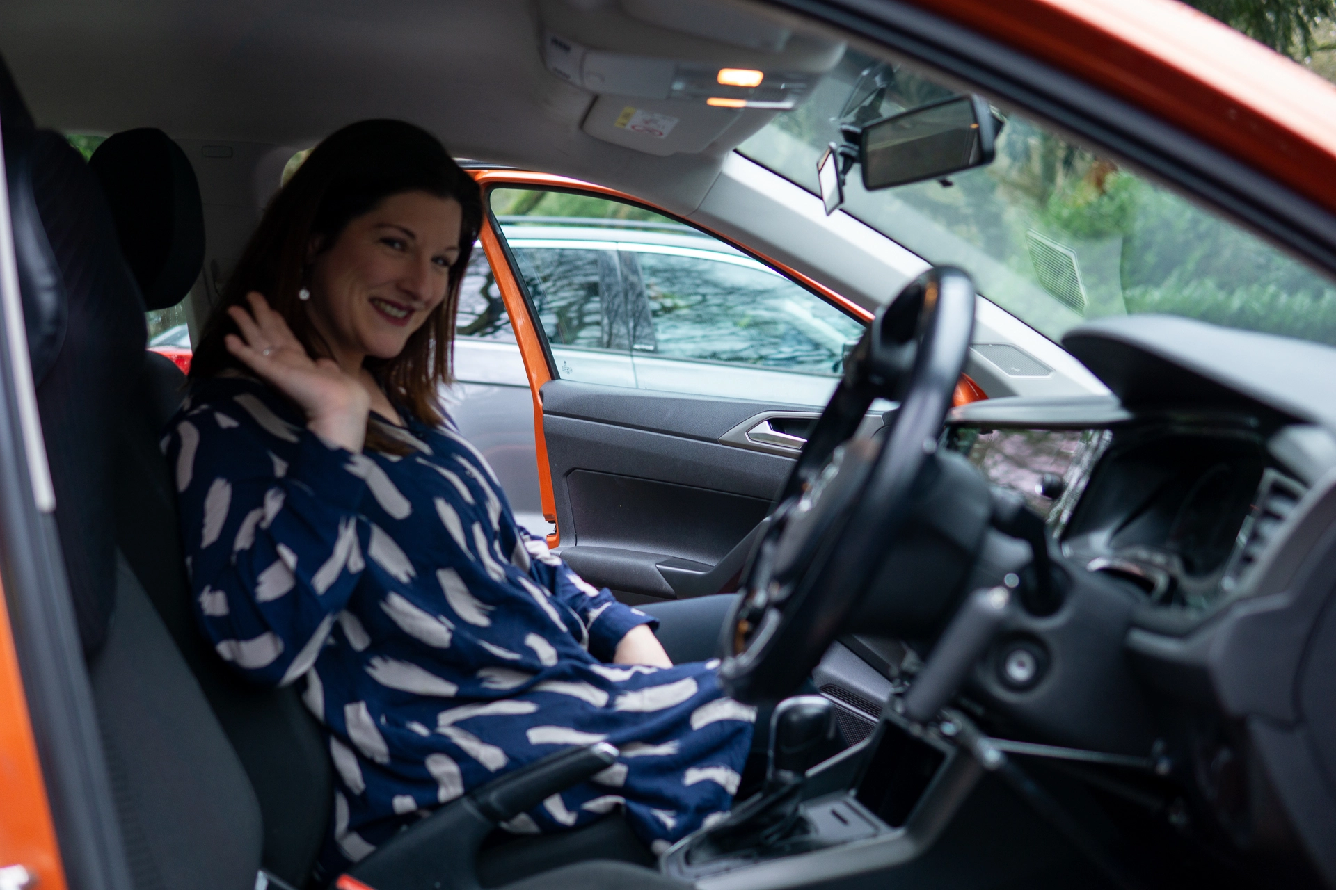 Louise waving from her automatic driving car